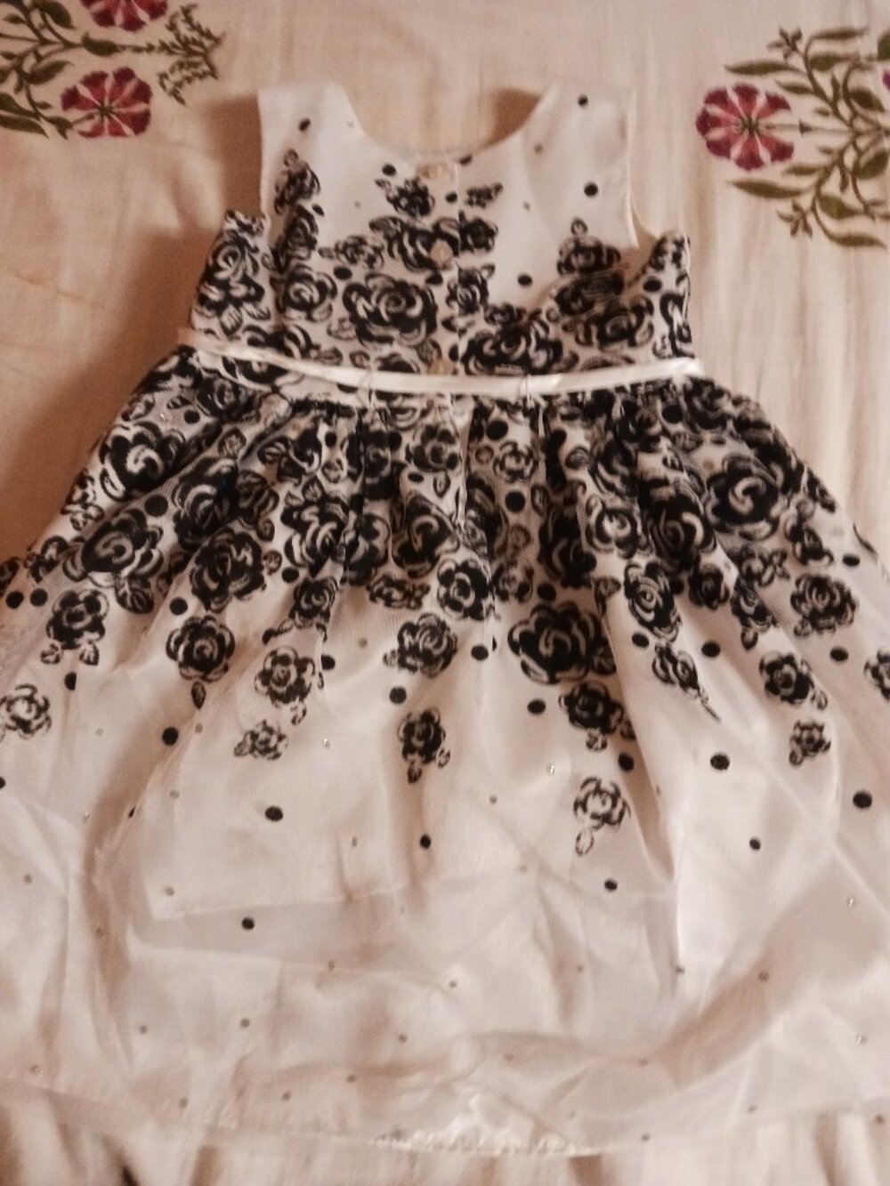 white and black floral dress with red rose detail